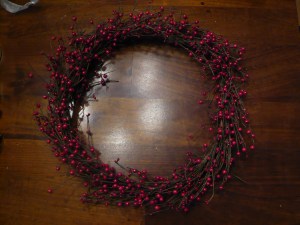 Berry garland wrapped into the shape of a wreath and secured with wire.
