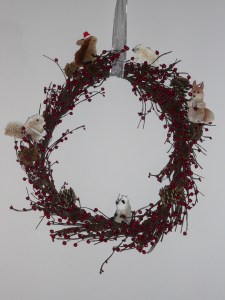 Wreath with large pine cones and critters added in.