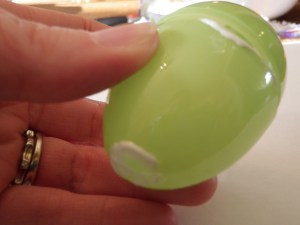 Begin by putting some glue where the egg closes. Then add glue to the top and bottom as you wrap the egg.