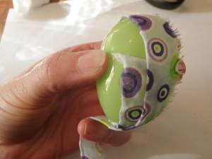 add glue to the eggs to secure the fabric.