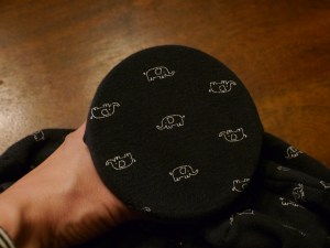 Place the smaller hoop behind the fabric and position the fabric so it's displayed the way you want it to be before securing the fabric in place.