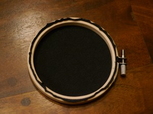After your fabric is secured, trim the fabric so the hoop can rest against the wall when hung.